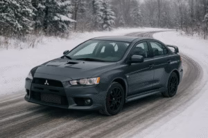 a Mitsubishi gray colour car driving on a snowy road
